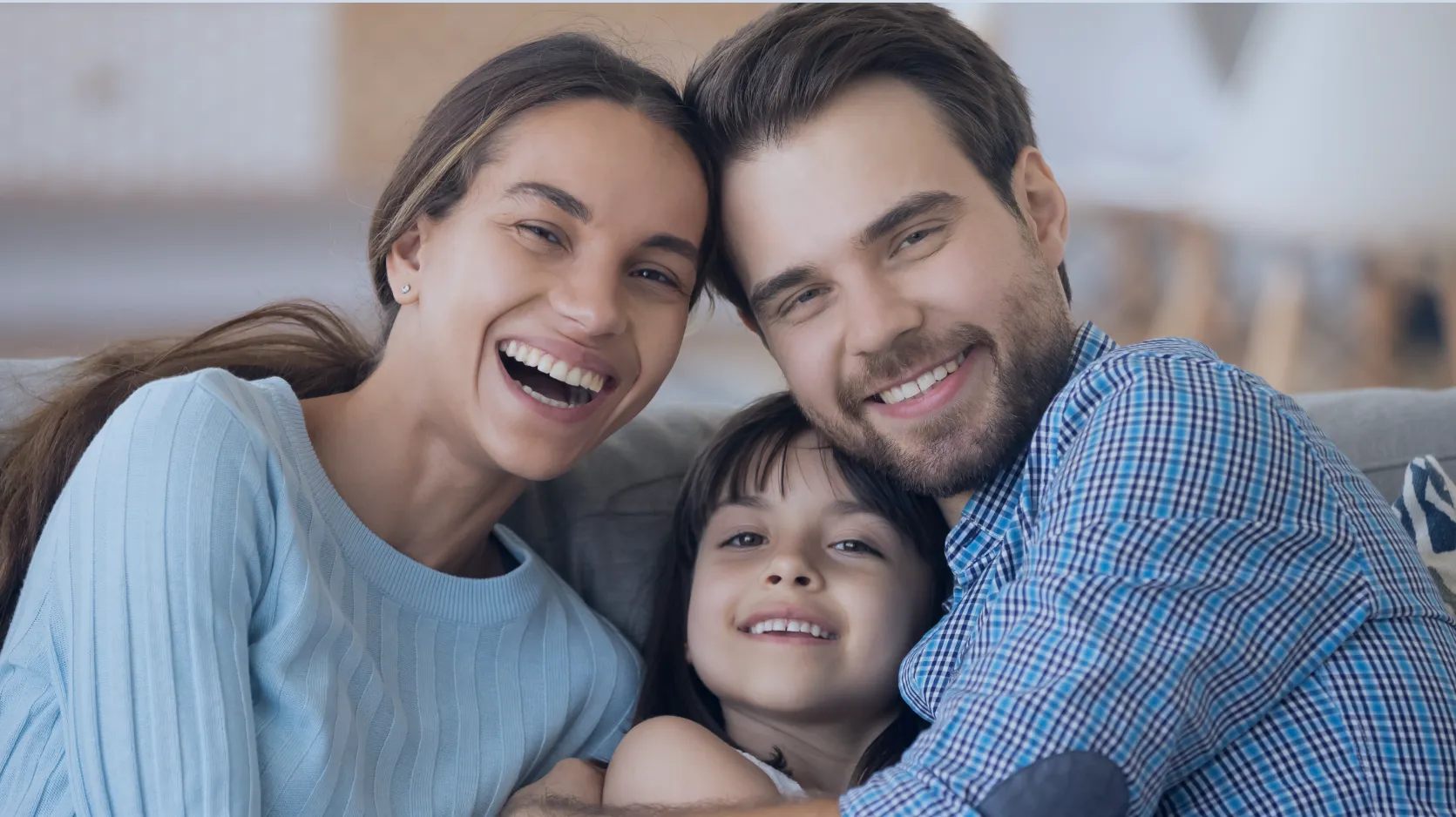 A family of three smiling together