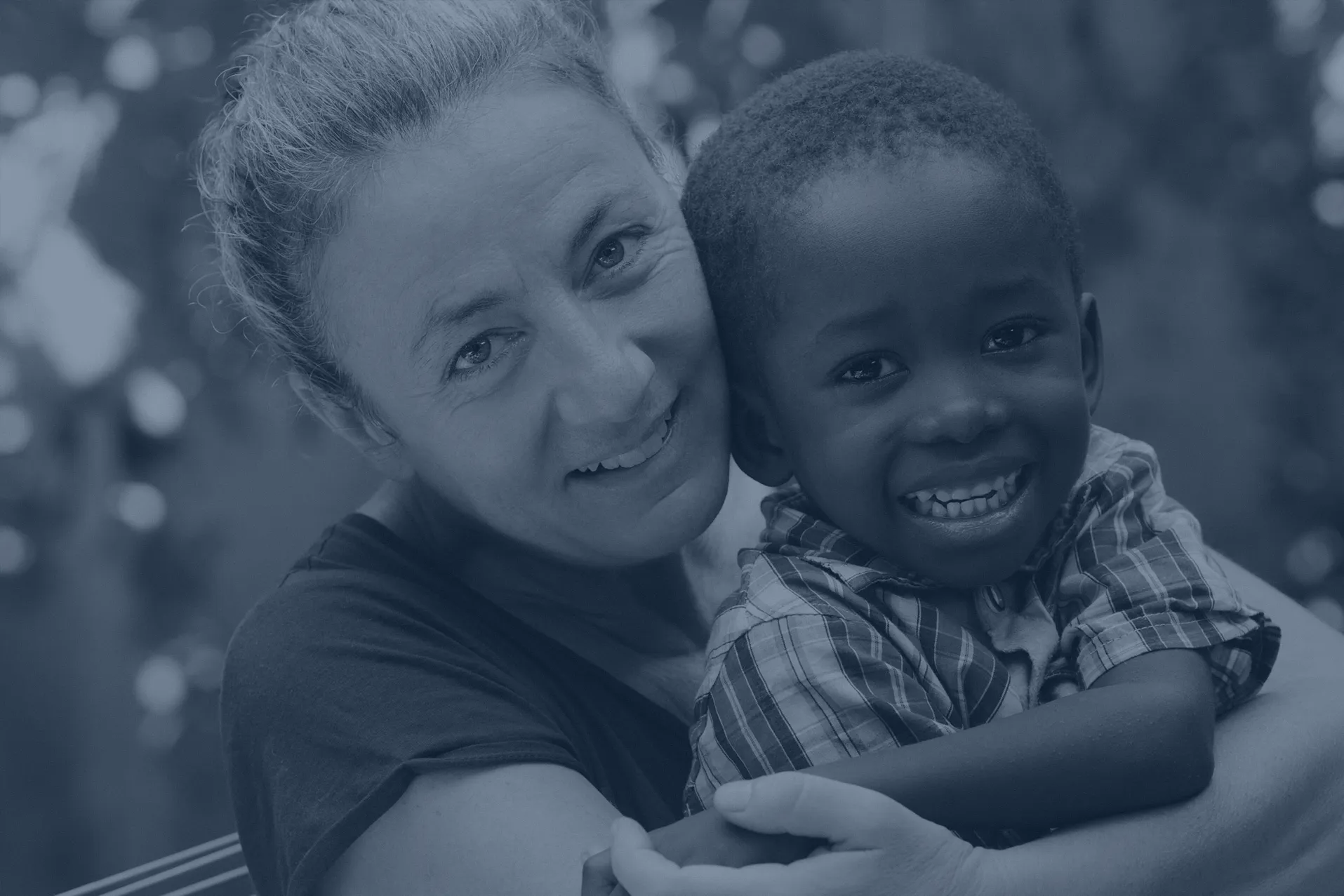 Volunteer embracing a young child